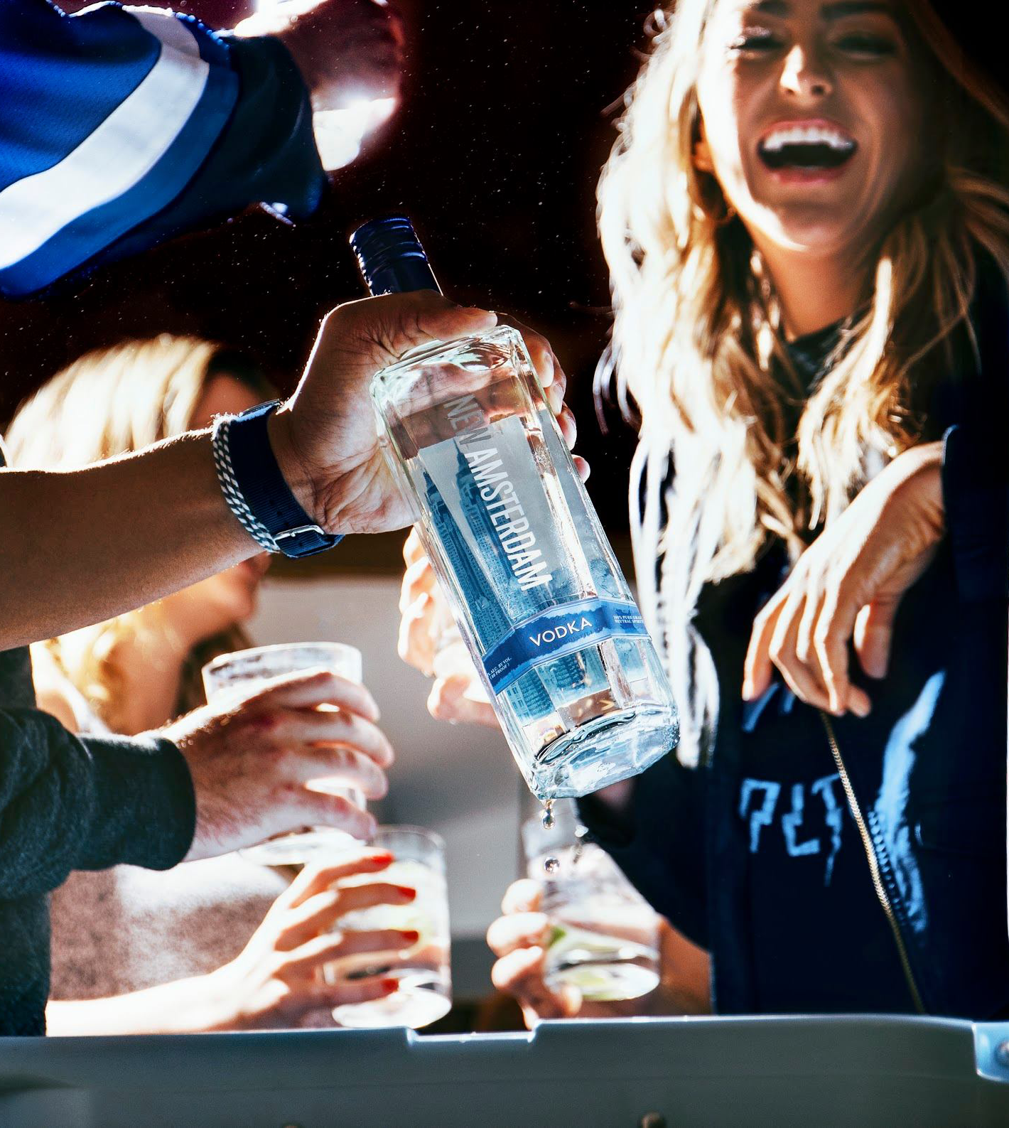 Woman and friends drinking NAM Vodka